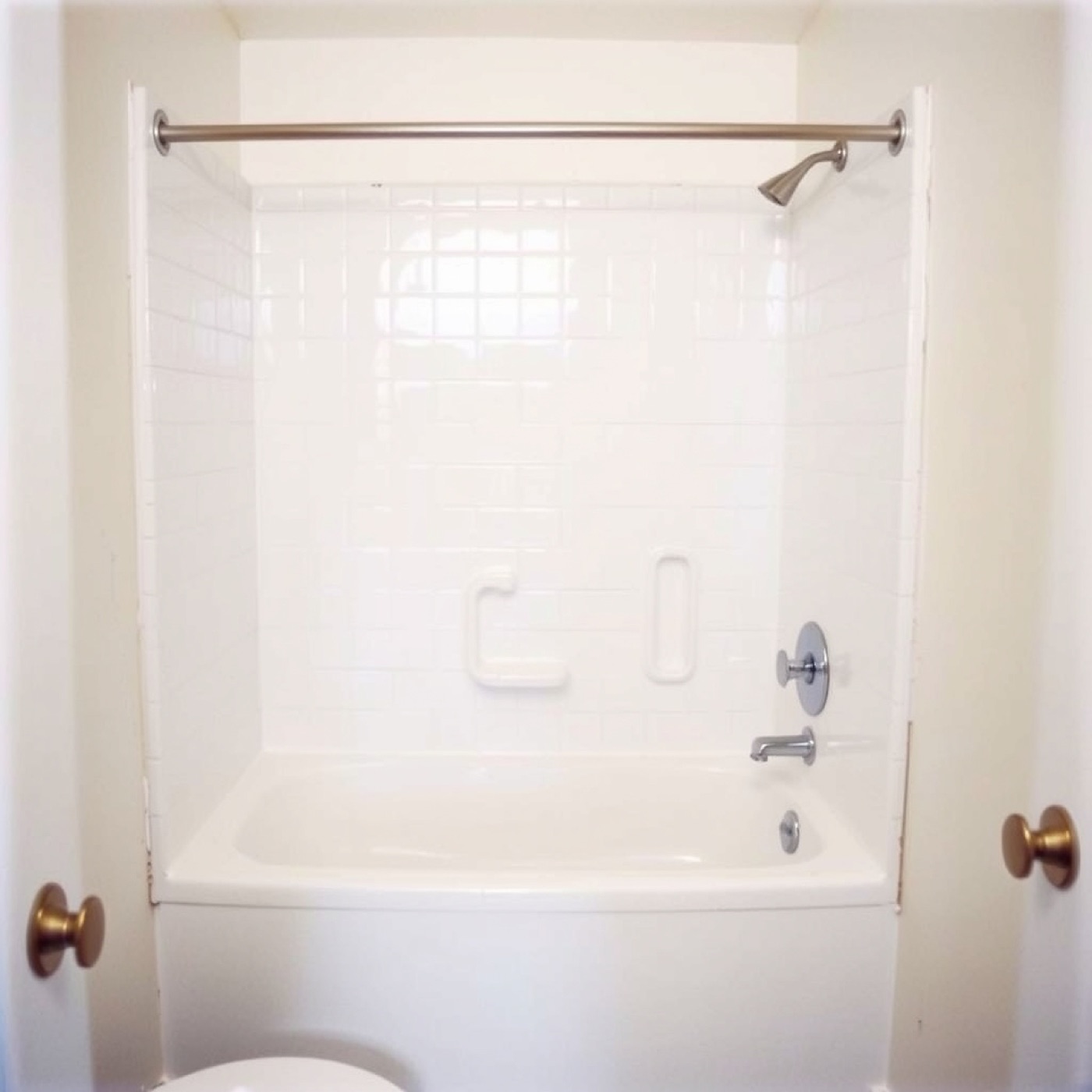 Resurfaced white tub surround with new fixtures, placeholder photo